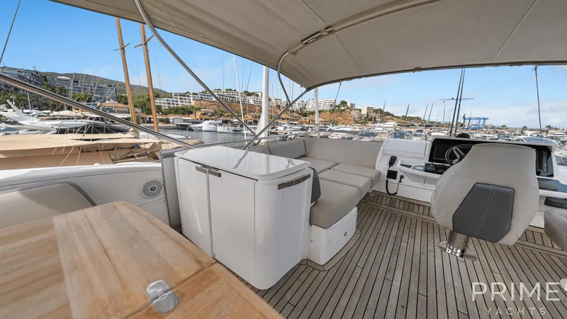  Yacht Photos Pics Luxurious 2019 Princess F49 yacht interior with seating and helm, docked in a marina.