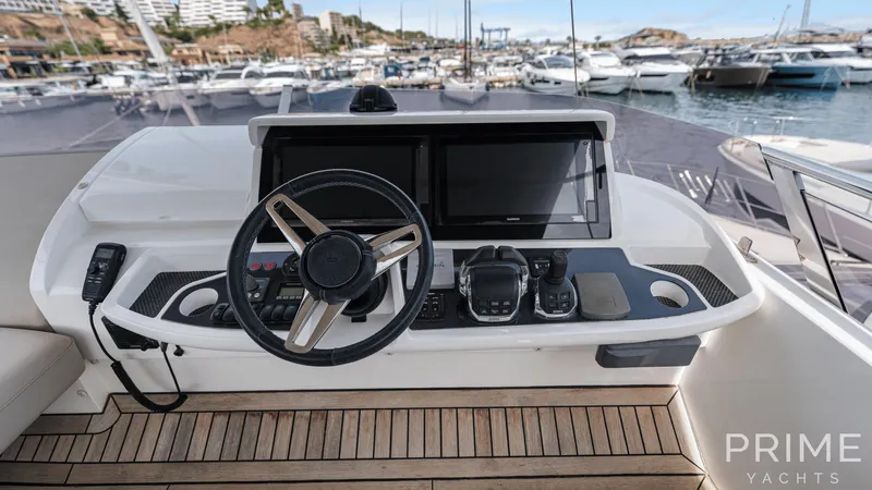  Yacht Photos Pics Helm of 2019 Princess F49 yacht with modern controls and marina view.