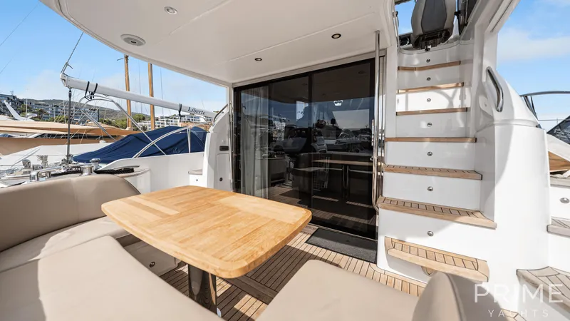  Yacht Photos Pics Luxurious 2019 Princess F49 yacht deck with seating and wooden table.