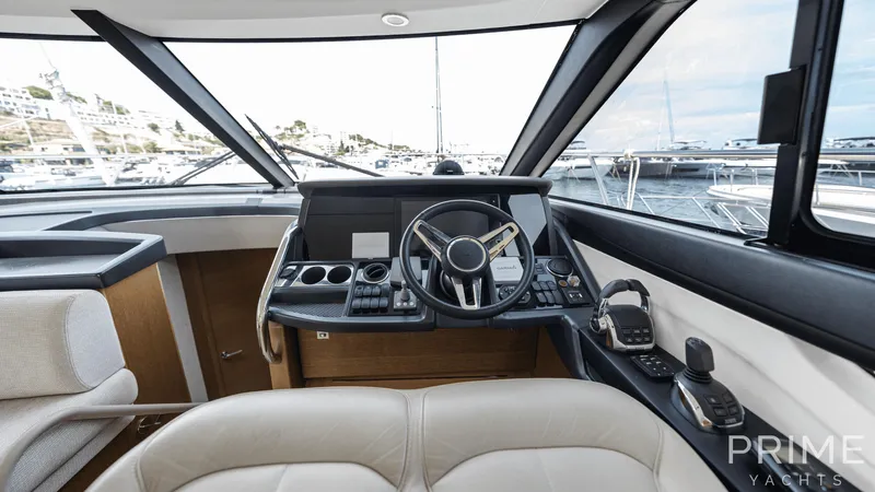  Yacht Photos Pics Luxurious 2019 Princess F49 yacht cockpit with modern steering and navigation controls.