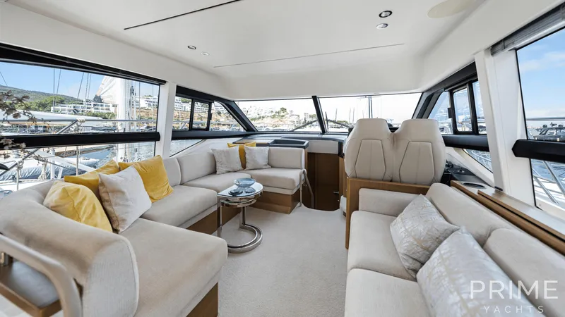  Yacht Photos Pics Luxurious interior of 2019 Princess F49 yacht with plush seating and panoramic windows.
