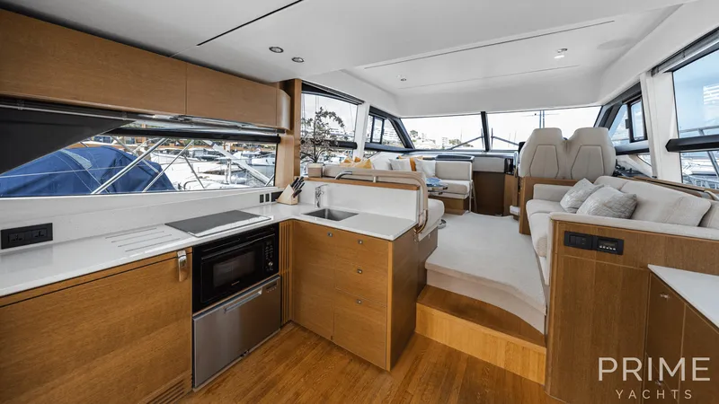  Yacht Photos Pics Luxurious interior of 2019 Princess F49 yacht with modern kitchen and seating area.