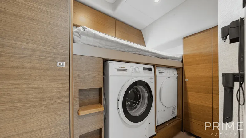  Yacht Photos Pics Laundry area with washer and dryer in 2019 Princess F49 yacht interior.