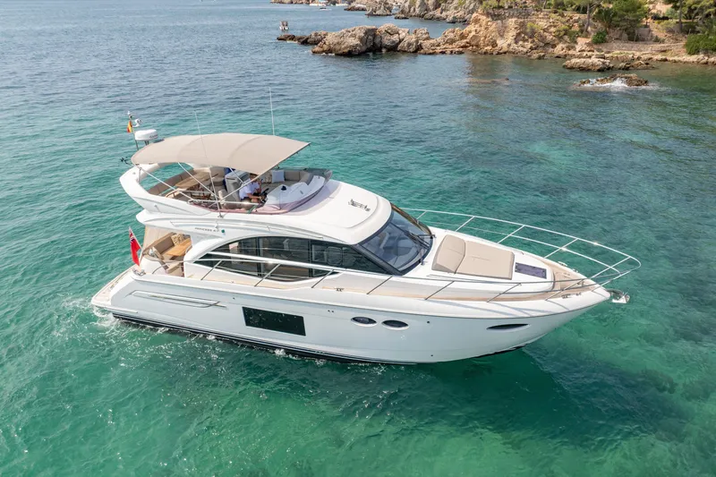  Yacht Photos Pics Luxurious 2019 Princess F49 yacht cruising in clear turquoise waters.