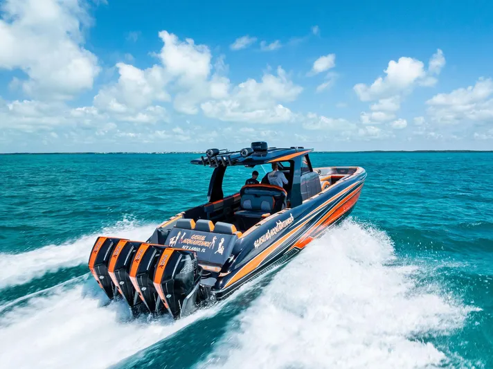 Casual Acquaintance Yacht Photos Pics 2024 Deep Impact 399 Sport boat cruising on turquoise ocean under clear blue sky.