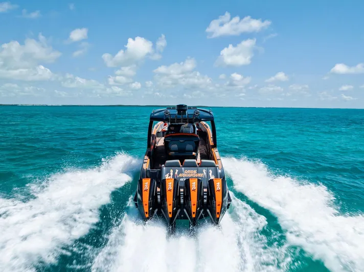 Casual Acquaintance Yacht Photos Pics 2024 Deep Impact 399 Sport boat speeding on turquoise ocean waters.