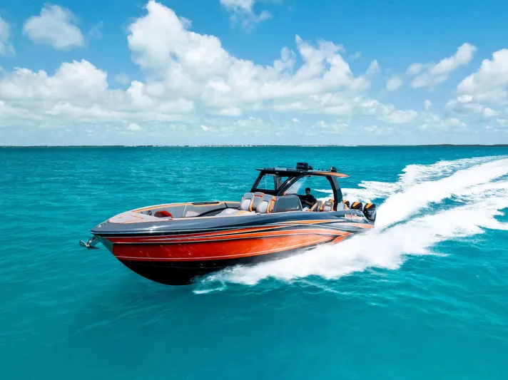 Casual Acquaintance Yacht Photos Pics 2024 Deep Impact 399 Sport boat cruising on clear blue ocean waters.