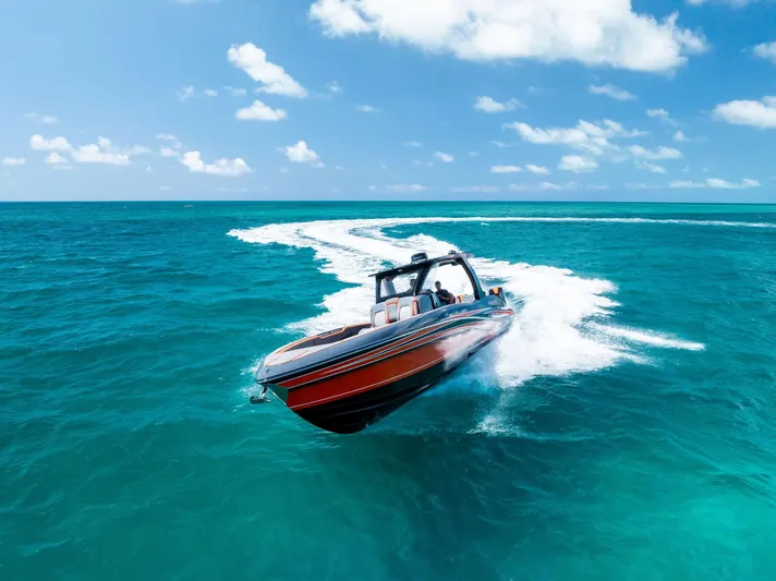 Casual Acquaintance Yacht Photos Pics 2024 Deep Impact 399 Sport boat speeding on turquoise ocean under clear blue sky.