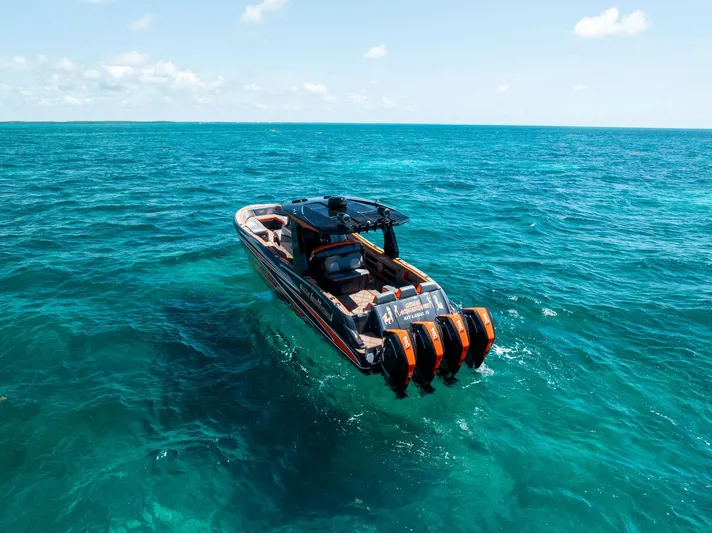 Casual Acquaintance Yacht Photos Pics 2024 Deep Impact 399 Sport boat on clear blue ocean waters.