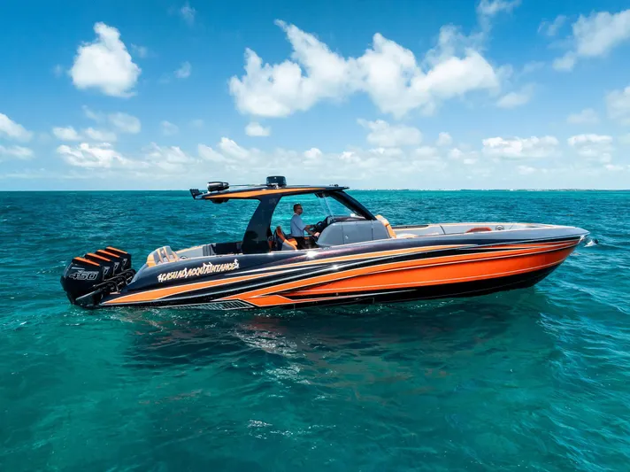 Casual Acquaintance Yacht Photos Pics 2024 Deep Impact 399 Sport boat cruising on clear blue ocean waters.