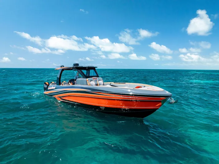 Casual Acquaintance Yacht Photos Pics 2024 Deep Impact 399 Sport boat cruising on clear blue ocean waters.