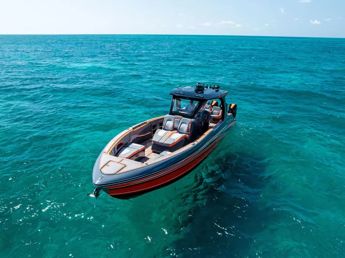 Casual Acquaintance Yacht Photos Pics 2024 Deep Impact 399 Sport boat cruising on clear blue ocean waters.