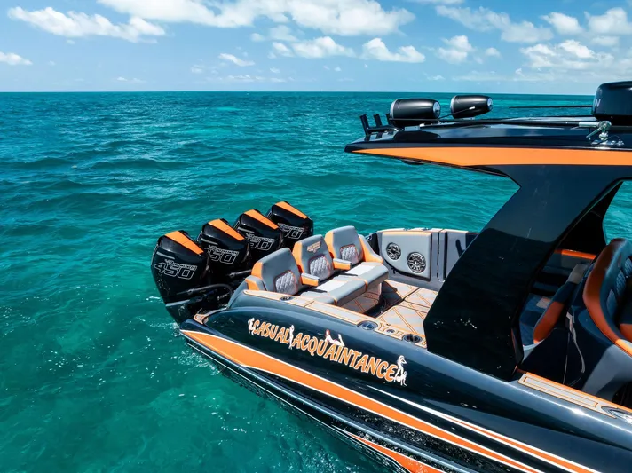 Casual Acquaintance Yacht Photos Pics 2024 Deep Impact 399 Sport boat on turquoise ocean, featuring sleek design and powerful engines.