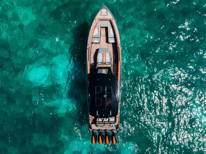 Casual Acquaintance Yacht Photos Pics Aerial view of 2024 Deep Impact 399 Sport boat on turquoise water.