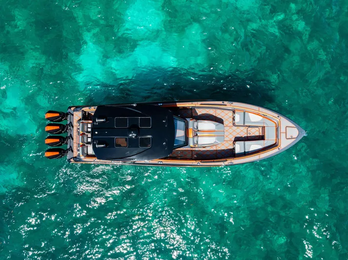 Casual Acquaintance Yacht Photos Pics Aerial view of 2024 Deep Impact 399 Sport boat on turquoise water.