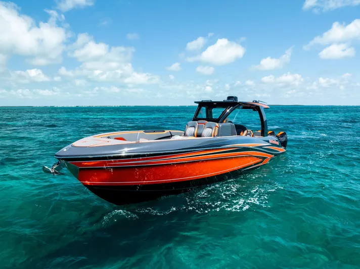 Casual Acquaintance Yacht Photos Pics 2024 Deep Impact 399 Sport boat on clear blue ocean water under a sunny sky.