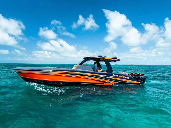 Casual Acquaintance Yacht Photos Pics 2024 Deep Impact 399 Sport boat cruising on clear blue ocean waters.