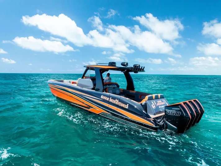 Casual Acquaintance Yacht Photos Pics 2024 Deep Impact 399 Sport boat cruising on clear blue ocean under a sunny sky.