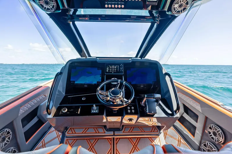 Casual Acquaintance Yacht Photos Pics 2024 Deep Impact 399 Sport boat cockpit with advanced navigation system on open water.