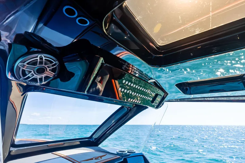 Casual Acquaintance Yacht Photos Pics Interior view of 2024 Deep Impact 399 Sport boat with ocean backdrop.