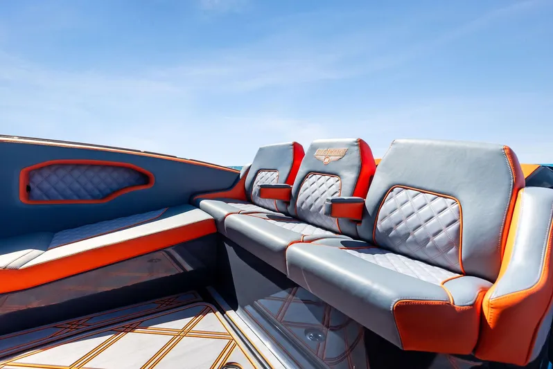 Casual Acquaintance Yacht Photos Pics 2024 Deep Impact 399 Sport boat interior with stylish seating and vibrant orange accents.