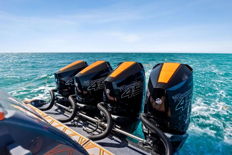 Casual Acquaintance Yacht Photos Pics 2024 Deep Impact 399 Sport boat with quad outboard engines on open sea.