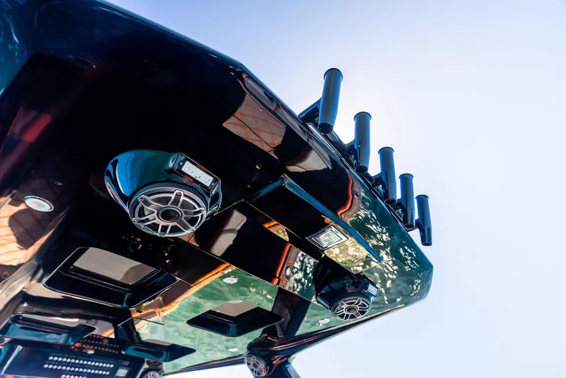 Casual Acquaintance Yacht Photos Pics 2024 Deep Impact 399 Sport boat, sleek design with speakers and rod holders, viewed from below.