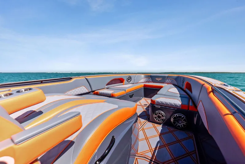 Casual Acquaintance Yacht Photos Pics 2024 Deep Impact 399 Sport boat interior with orange and gray seating, ocean view.