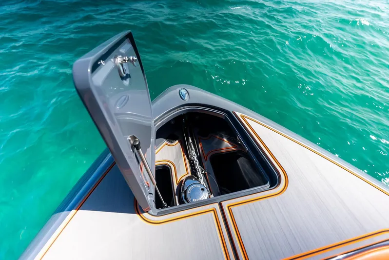 Casual Acquaintance Yacht Photos Pics Open storage compartment on 2024 Deep Impact 399 Sport boat, floating on turquoise water.