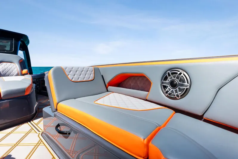 Casual Acquaintance Yacht Photos Pics 2024 Deep Impact 399 Sport boat interior with orange and gray seating, ocean view.