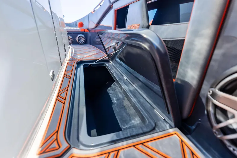 Casual Acquaintance Yacht Photos Pics 2024 Deep Impact 399 Sport boat with open storage compartment, featuring sleek design and orange accents.