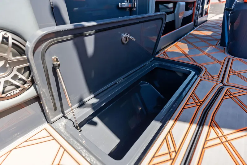 Casual Acquaintance Yacht Photos Pics Open storage compartment on 2024 Deep Impact 399 Sport boat with stylish flooring.