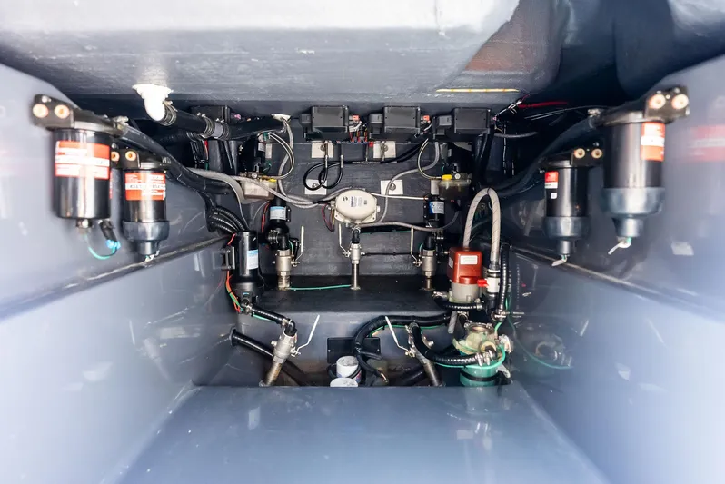 Casual Acquaintance Yacht Photos Pics Engine compartment of 2024 Deep Impact 399 Sport boat, showcasing mechanical components and wiring.
