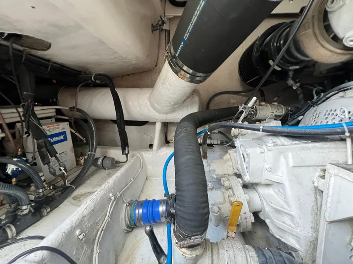  Yacht Photos Pics Engine room of 2001 Ocean 52 Convertible boat with visible hoses and machinery.