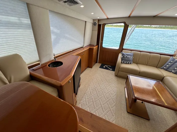  Yacht Photos Pics Luxurious interior of 2001 Ocean 52 Convertible yacht with elegant seating and wood finishes.