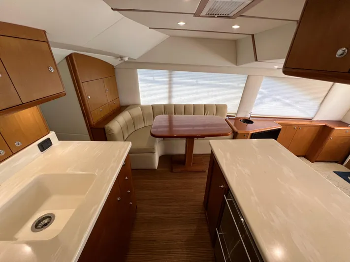  Yacht Photos Pics Interior of 2001 Ocean 52 Convertible yacht with kitchen and dining area.