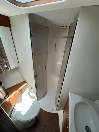  Yacht Photos Pics Bathroom interior of 2001 Ocean 52 Convertible yacht, featuring shower and sink.
