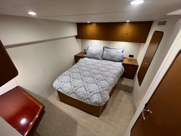  Yacht Photos Pics Cozy bedroom in 2001 Ocean 52 Convertible yacht with elegant wood accents.