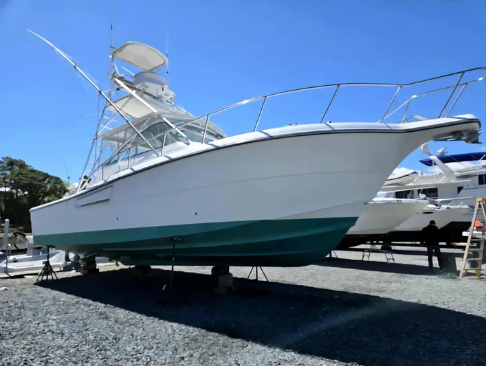 Side Chick Yacht Photos Pics 2002 Rampage 38 Express boat on dry dock.