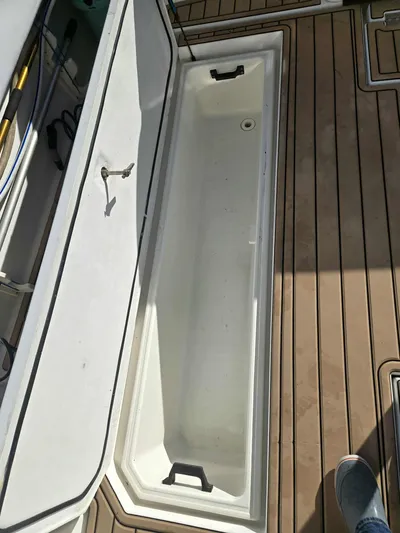 Side Chick Yacht Photos Pics Open storage compartment on a 2002 Rampage 38 Express boat.