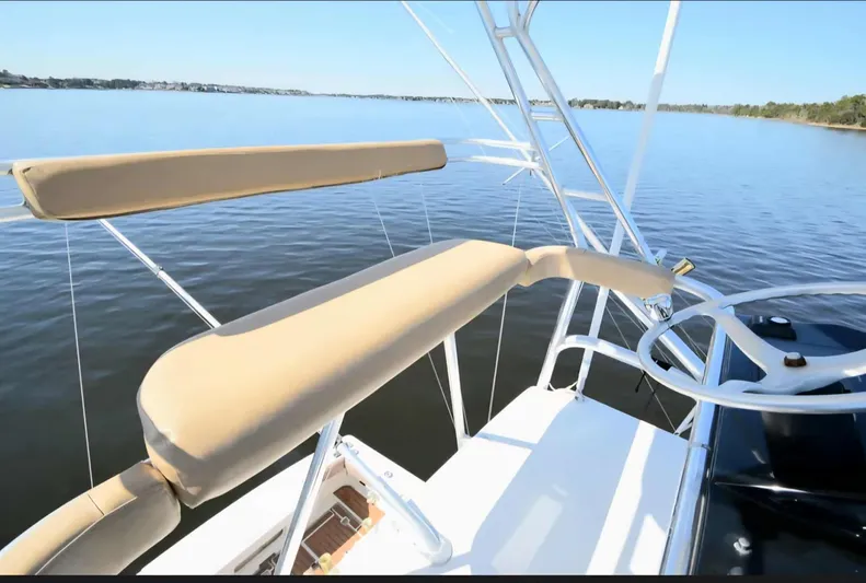 Side Chick Yacht Photos Pics 2002 Rampage 38 Express boat on calm water.