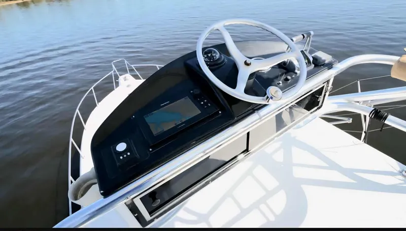 Side Chick Yacht Photos Pics Helm of 2002 Rampage 38 Express on calm water.