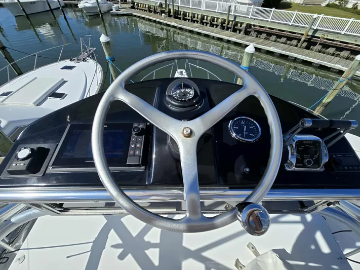 Side Chick Yacht Photos Pics Helm of 2002 Rampage 38 Express at dock.