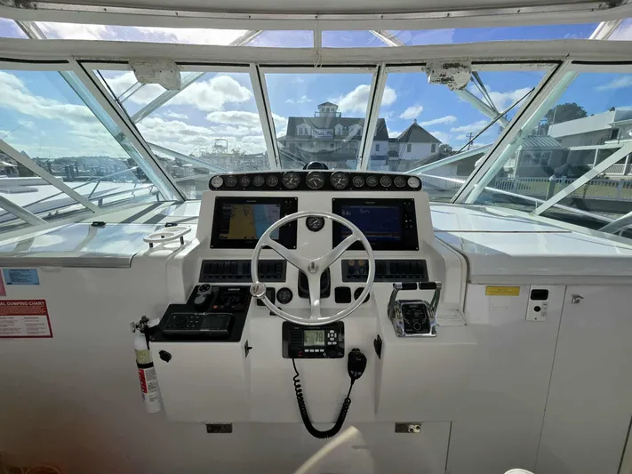 Side Chick Yacht Photos Pics 2002 Rampage 38 Express helm with instruments and controls.