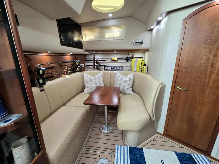 Side Chick Yacht Photos Pics Interior of a 2002 Rampage 38 Express yacht with cozy seating area.