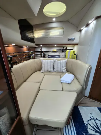 Side Chick Yacht Photos Pics Interior of a 2002 Rampage 38 Express yacht with beige sofa.