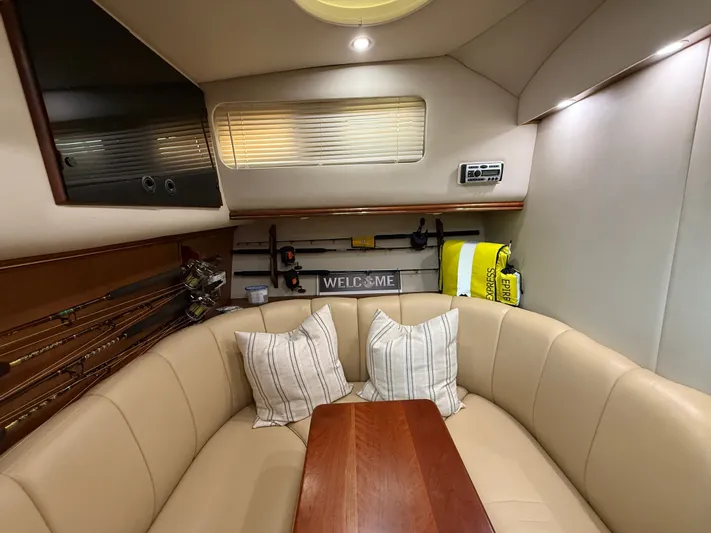 Side Chick Yacht Photos Pics Interior of a 2002 Rampage 38 Express yacht with cozy seating area.