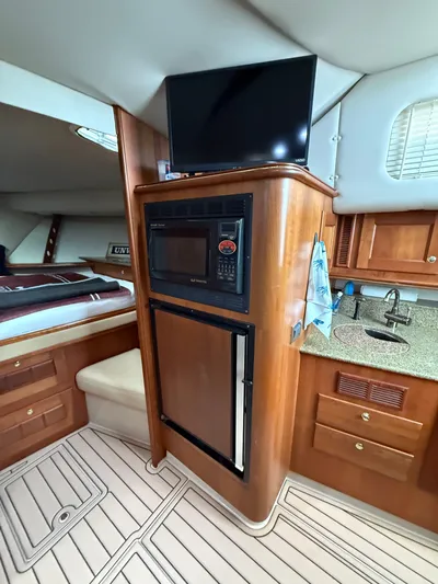 Side Chick Yacht Photos Pics Interior of a 2002 Rampage 38 Express yacht with kitchenette.