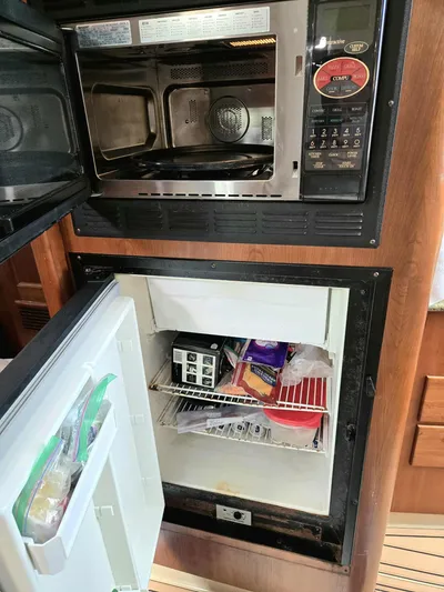 Side Chick Yacht Photos Pics Microwave and fridge in 2002 Rampage 38 Express boat.