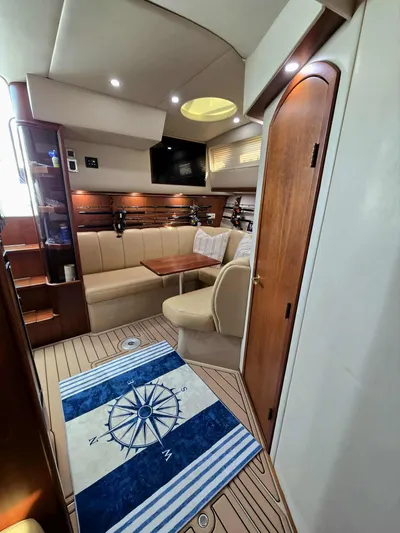 Side Chick Yacht Photos Pics Interior of a 2002 Rampage 38 Express yacht with cozy seating area.